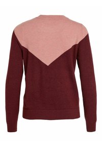 Röd och rosa tröja med v-formad färgblockdesign, långa ärmar och ett texturerat stickat material. Ren linje vid fållen.