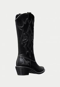Black leather cowboy boots with decorative stitching, pointed toe, and stacked heel. Features a side pull tab and detailed patterns on the shaft.