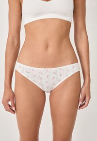 Sous-vêtements blancs avec des motifs floraux et des rayures verticales, fabriqués en tissu doux, avec un nœud décoratif à l'avant et une bordure en dentelle.