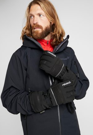 Black insulated gloves with ribbed design and white accents. Made of textured material, featuring adjustable straps for a secure fit.