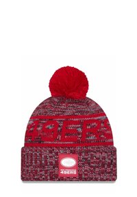 Rote Strickmütze mit einem Pompons oben, ausgestattet mit einem gewebten Muster und einem Vorderetikett, das das Logo der "SAN FRANCISCO 49ERS" zeigt.