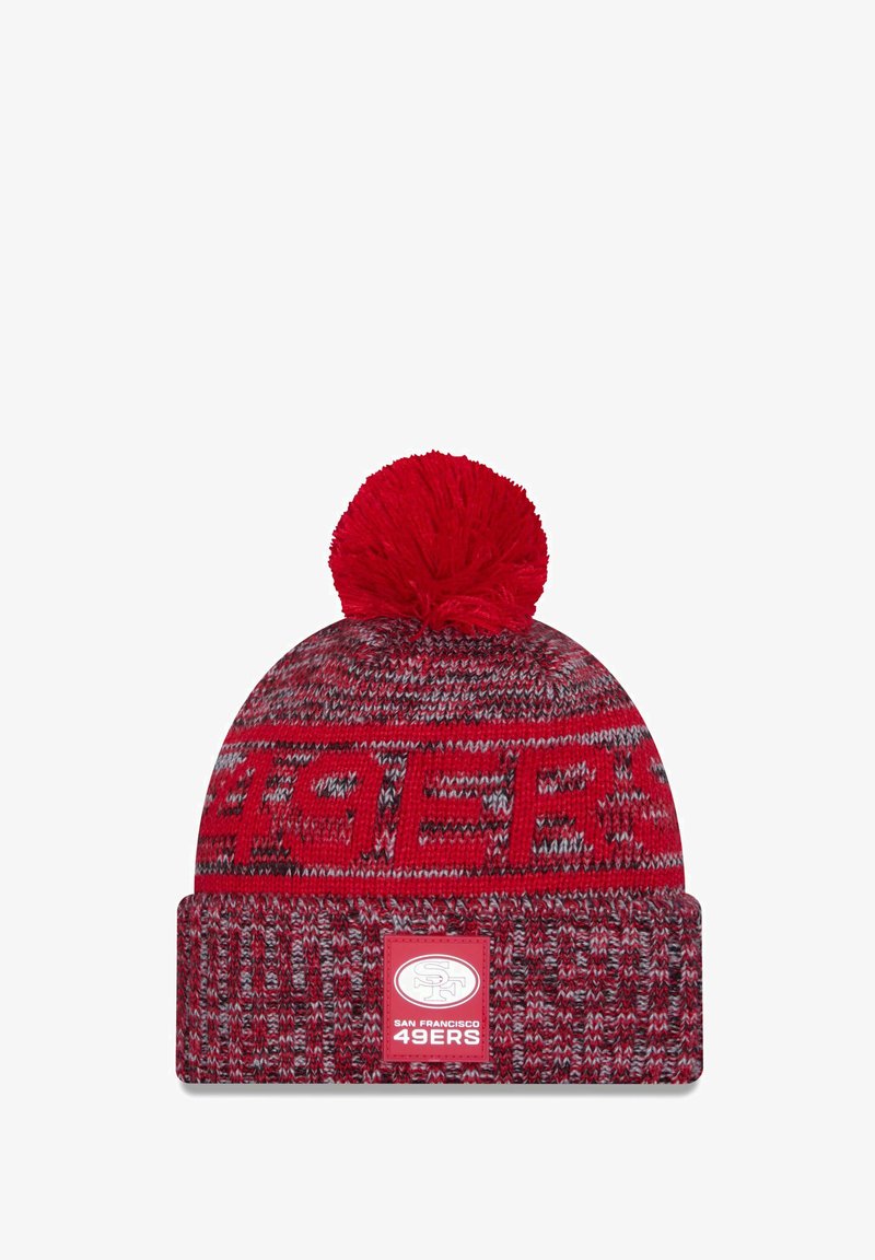 Red knit beanie with a pom-pom on top, featuring a woven pattern and a front patch displaying "SAN FRANCISCO 49ERS" logo.