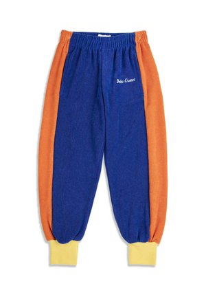 Blå og orange fleece joggingbukser med gule ribkanter og elastik i taljen, med "Bobo Choses" broderet på frontlommen.