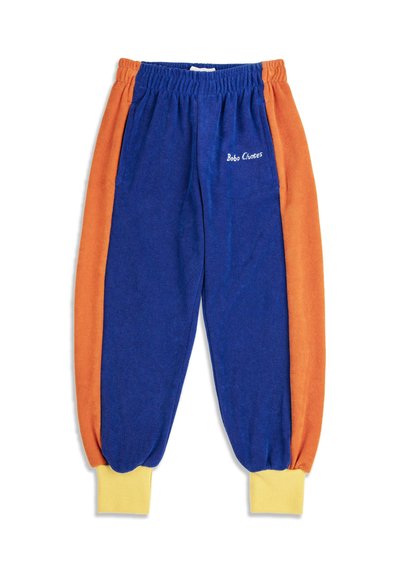 Pantaloni jogger in pile blu e arancione con polsini a coste gialli e vita elasticizzata, con "Bobo Choses" ricamato sulla tasca frontale.
