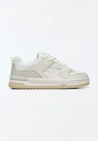 Biele tenisky s textúrovaným zvrškom, sieťovinovými prvkami a hrubou gumovou podrážkou. Majú zaoblenú špičku a jednoduché šnurovanie.