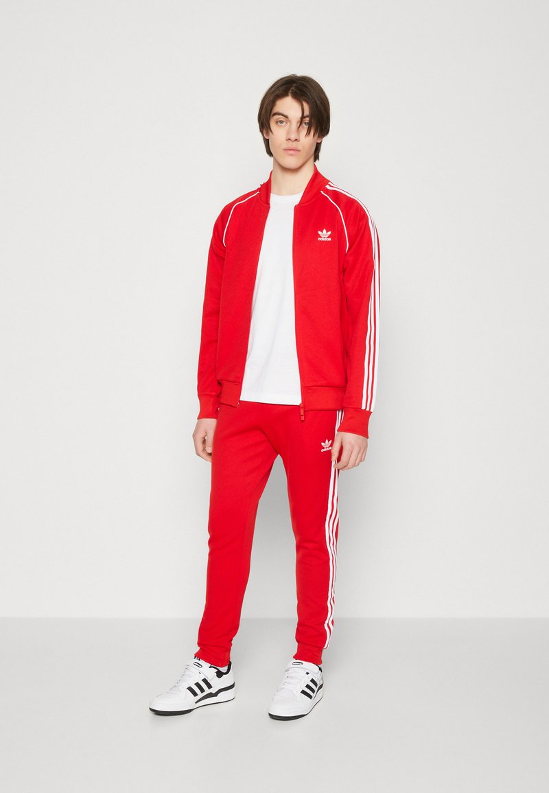 adidas Originals - ADICOLOR CLASSICS SUPERSTAR TRACK PANTS - Tracksuit bottoms - better scarlet/white, Enlarge
