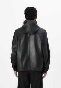 COACH REVERSIBLE TRAINER - Kožnata jakna - black/charcoal