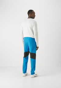 Nike Performance Jogginghose - light photo blue/black/white