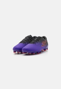 Purple soccer cleats with black accents, textured upper, and red studs. Features a perforated pattern and lace-up design.