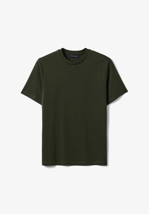 T-shirt verde scuro a maniche corte con scollo tondo e piccola etichetta nera e dorata sull'orlo inferiore su sfondo bianco.