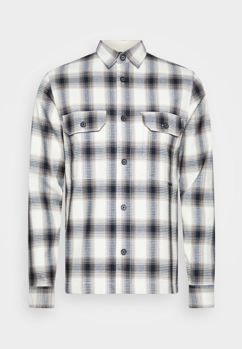 Langsleevige zwart-witte en grijze geruite overhemden met twee knoopzakken op de borst en een kraag.