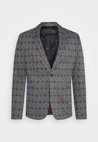 Grijze blazer met een ruitpatroon en rode accenten. Gemaakt van een gestructureerde stof met een enkele knoopsluiting en notch-kraag.