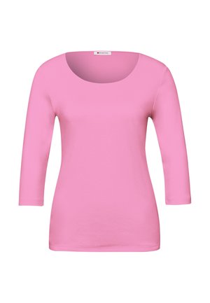Růžové dámské tričko s dlouhým rukávem, přiléhavé, s kulatým výstřihem a malou značkovou cedulkou na límci.