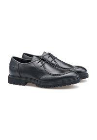 Scarpe in pelle nera con finitura liscia, punta arrotondata e cuciture decorative. Presentano una suola in gomma spessa e strutturata per una migliore aderenza.