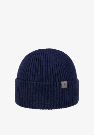 Navy blue ribbed knit beanie with folded cuff and small rectangular fabric logo tag on the side.