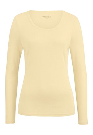 Langschildige top van zachte, biologische katoen in een lichte gele kleur. Heeft een ronde halslijn en een aangesloten silhouet met eenvoudige stikdetails.