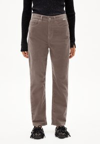 Brown corduroy pants with a straight leg design, featuring front pockets and a button closure, paired with black textured shoes.