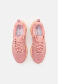 Pair of pink athletic shoes with mesh uppers and beige soles, viewed from above on a white background.