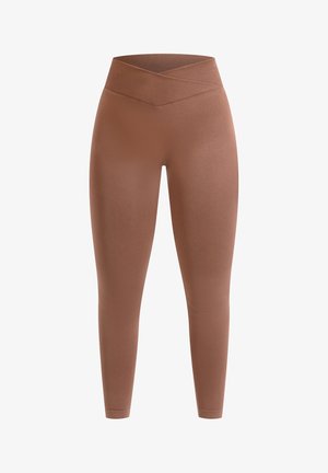 Bruine legging met een naadloze, hoog uitgesneden tailleband met een kruisvormig ontwerp. Gemaakt van rekbaar, glad materiaal, geschikt voor actieve kleding.