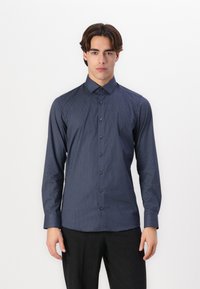 Navy blue long-sleeve shirt with a subtle geometric pattern, button-up front, and collar; made from a smooth fabric.