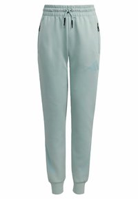Light blue track pants made from textured fabric, featuring an elastic waistband, adjustable drawstring, and side zip pockets.