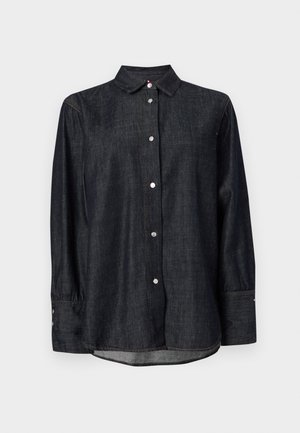 Mørk denimskjorte med klassisk krage, lange ermer, knappestengning og subtile søm-detaljer. Glatt tekstur med en avslappet passform.