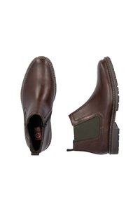 Bottines en cuir marron avec des panneaux latéraux élastiques, des accents verts texturés etune semelle en caoutchouc robuste. Présente des coutures le long des bords.