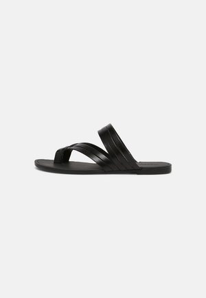 Black leather slide sandal featuring cross-strap design, flat sole, and smooth texture. Simple and modern style with minimalist details.