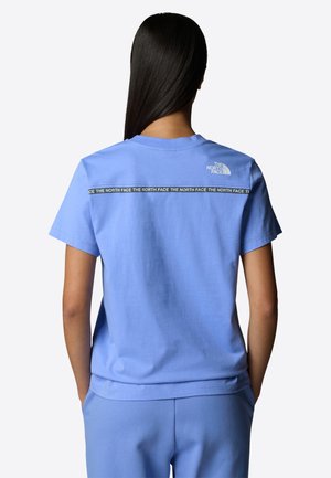 Light blue cotton t-shirt with short sleeves, featuring a black logo panel at the back, and a crew neckline. Smooth texture.