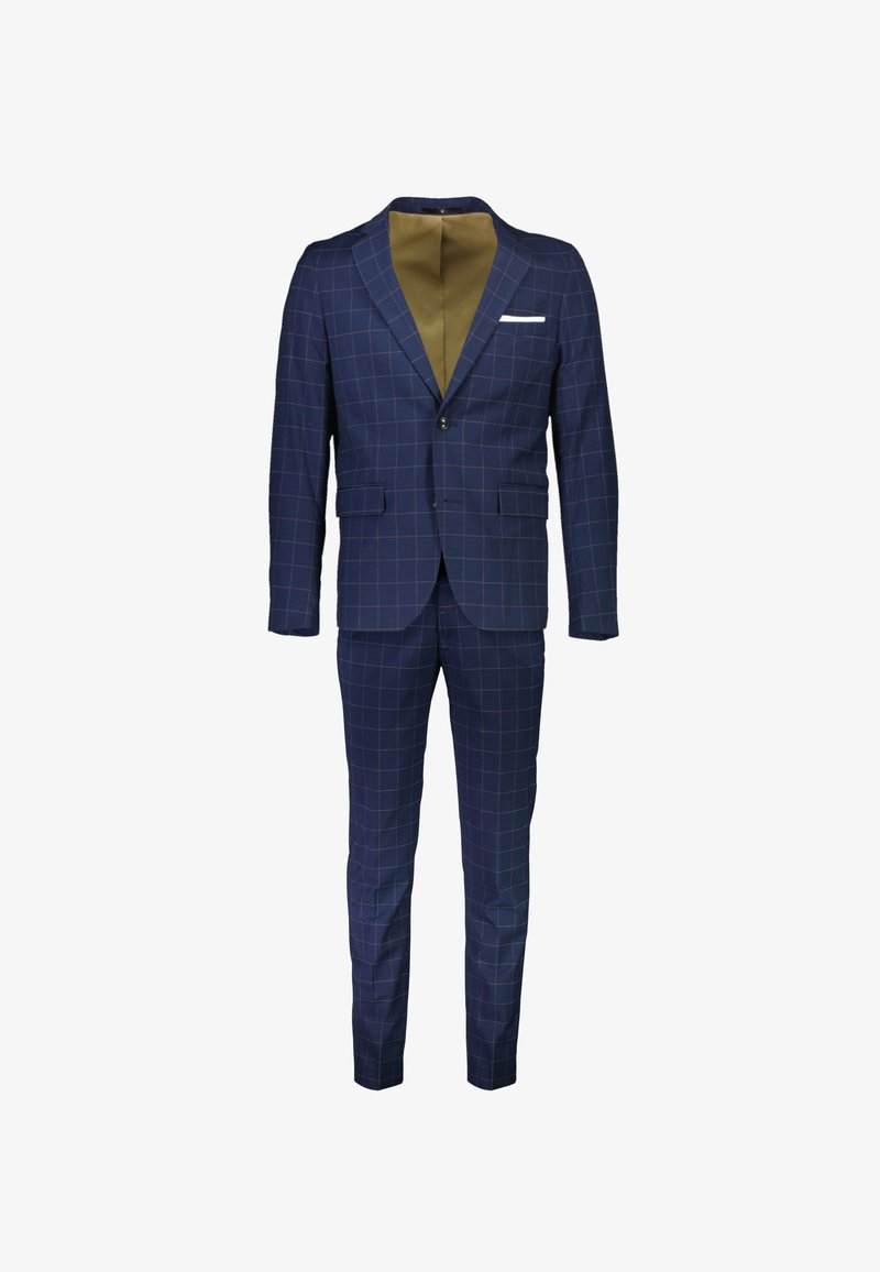 Laivastonsininen puku, jossa on vaalea ruutukuvio, yksirivinen nappilista, läppätaskut, valkoinen taskuliina ja sopivat slim-fit-housut.