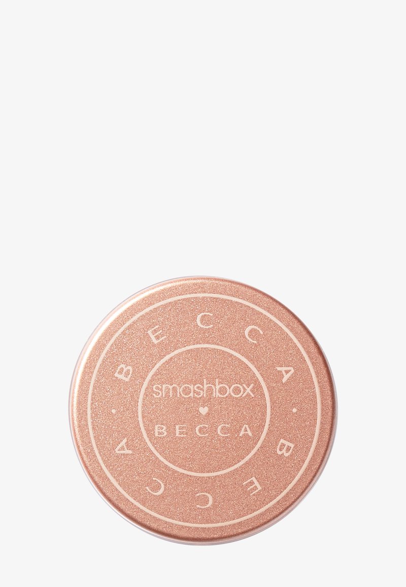Round compact with a rose gold metallic finish, featuring embossed text indicating "smashbox" and "BECCA" on the lid.