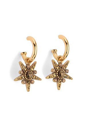 Gold-tone hoop earrings featuring a star-shaped design with intricate detailing, black accents, and small rhinestone embellishments.