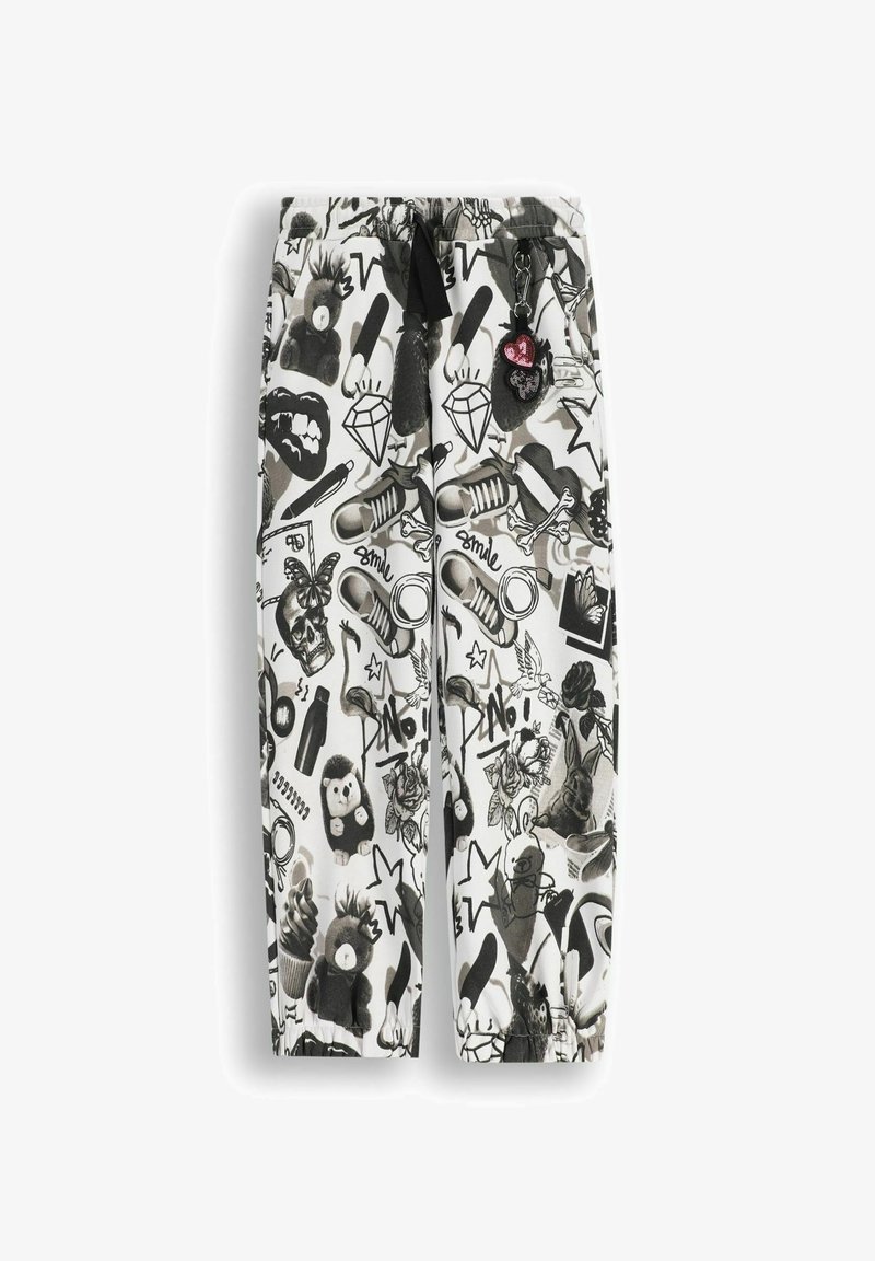 Czarno-białe spodnie w wzory z różnymi grafikami, takimi jak zwierzęta, diamenty i tatuaże. Zaprojektowane z elastycznym pasem i sznurkiem do wiązania.