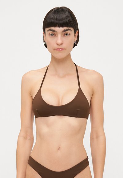 Braunes Bikini-Oberteil mit dreieckigem Design und dünnen Trägern, aus glattem Stoff. Der unteren Teil besteht aus passenden braunen Badehosen.
