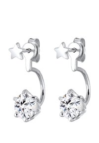 Boucles d'oreilles en argent en forme de créole, avec un clou en forme d'étoile et une grande pierre précieuse claire dans un sertissage à six griffes, mettant en avant un design moderne et épuré.