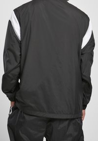 Starter Cortaviento - black
