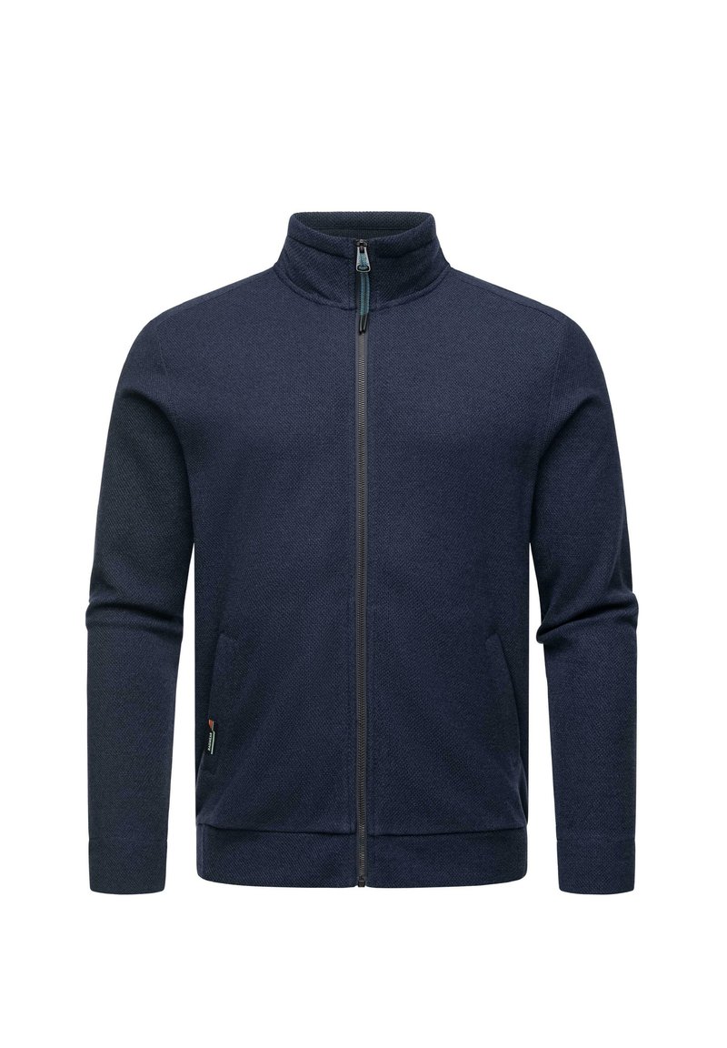 Giacca zip-ponte blu navale con colletto alto, tessuto strutturato, due tasche laterali e un piccolo etichetta con logo sul lato sinistro.