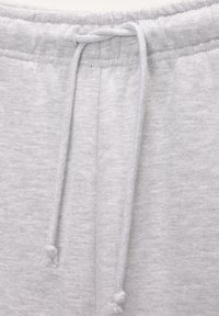 Grau Baumwoll-Sweatpants mit einem elastischen Bund und einem Kordelzug, glatter Textur und einem lässigen Design.