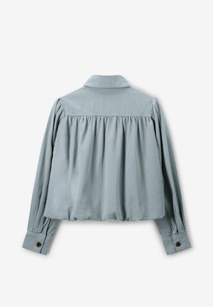 Light blue, collared cropped shirt with long sleeves, gathered back, and buttoned cuffs. Made of smooth, lightweight fabric.