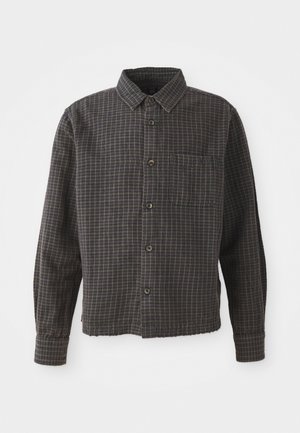 Long-sleeve button-up shirt in gray and black plaid, featuring a collared neck, single chest pocket, and a slightly cropped hem.
