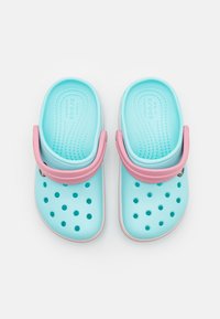 Light blue clogs with pink straps, made of flexible material. Features ventilation holes and a textured footbed. Rounded toe and heel design.
