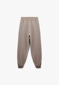 Lysebrune sweatpants med elastisk talje og samlet ankler. Fremstillet af blødt, glat stof med en afslappet pasform.