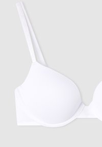 Reggiseno bianco con coppe lisce e imbottite, spalline regolabili e design senza cuciture. Realizzato in tessuto morbido e elasticizzato per il comfort.