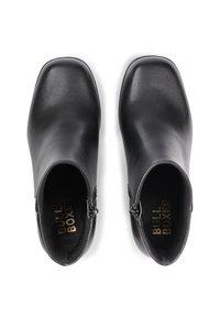 Black leather ankle boots with a square toe design and side zippers. Features a smooth texture and branded gold lettering inside.