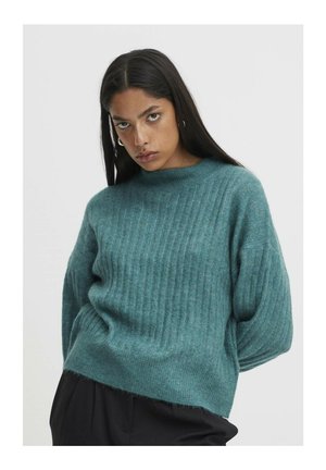 Teal ribbed sweater made of soft textured fabric; features a round neckline and dropped shoulders, with a slightly cropped silhouette.
