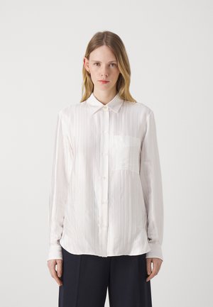 White long-sleeve shirt with vertical stripes, button front, point collar, and single chest pocket. Smooth fabric with a relaxed fit.