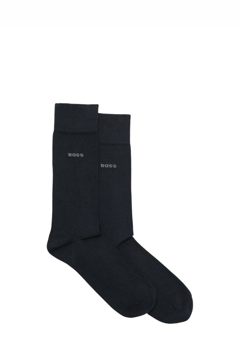 Calzini neri con una texture liscia e un bordo a coste. Presentano un discreto logo "BOSS" grigio sul lato. Design standard con lunghezza alla caviglia.