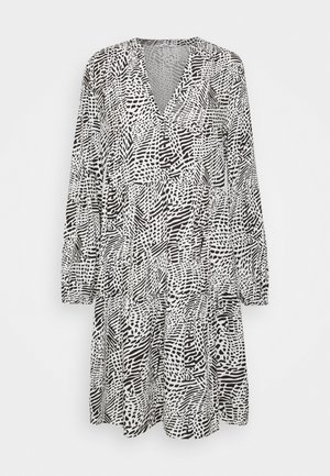 Black and white patterned dress with long sleeves, V-neckline, and gathered waist, featuring abstract shapes and textures throughout.