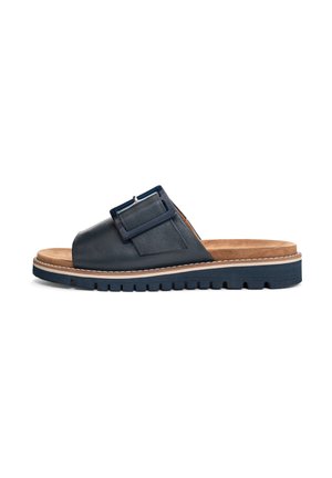 Dark blue leather slide sandal with a wide strap, adjustable buckle detail, and a textured sole; includes a cushioned tan footbed.