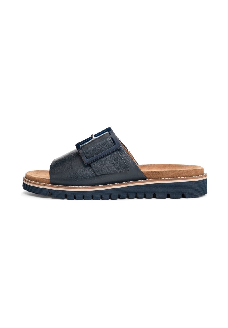 Dark blue leather slide sandal with a wide strap, adjustable buckle detail, and a textured sole; includes a cushioned tan footbed.